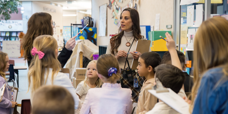 Principal for a Day students discuss something with Prairie Winds Elementary Principal, Kimberly Runyon