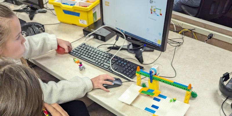 students work with lego robotics and computers