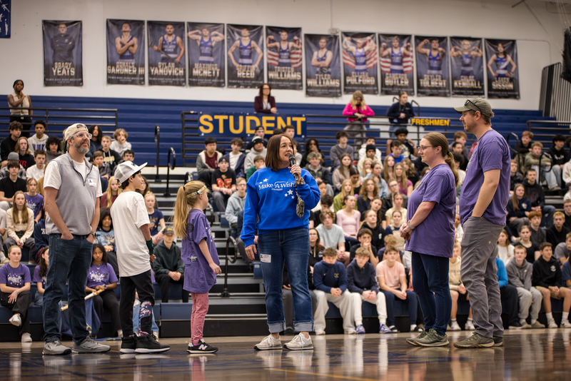 Tina Stroman from Make A Wish addresses the crowd with Brooks and her family around