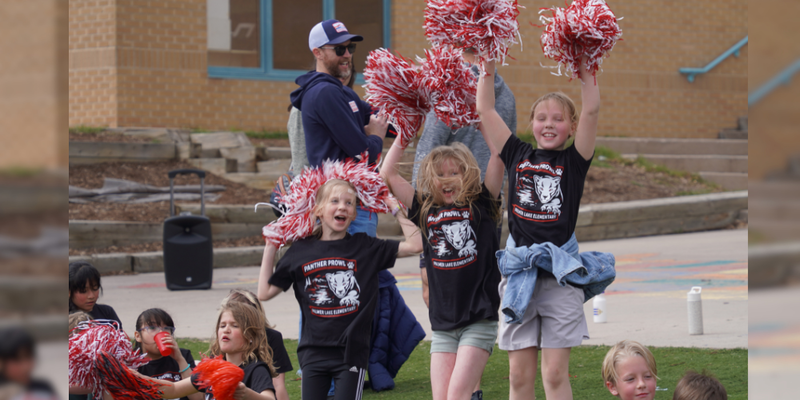 Palmer Lake Elementary students cheer on and give high fives to other students as they run during the Panther Prowl