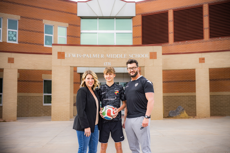 Max standing with his mother and father in front of LPMS