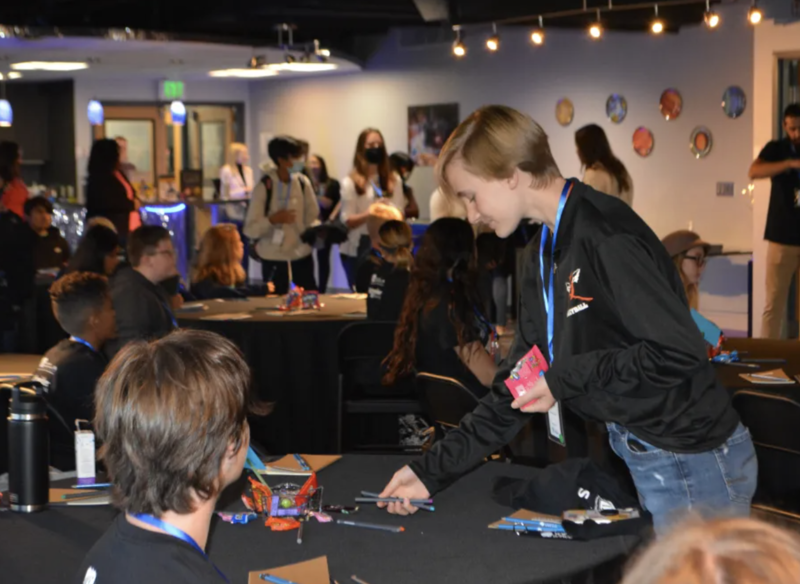 Student engaging with STEAM related presentation on table