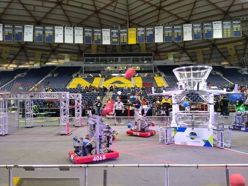 Picture of various robots on competition floor in stadium