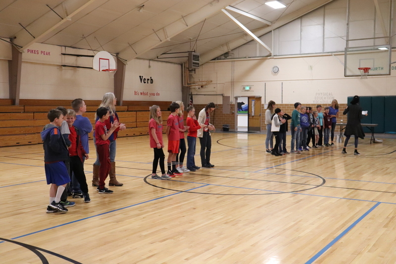 Groups of students lined up in school auditorium to compete in tournament