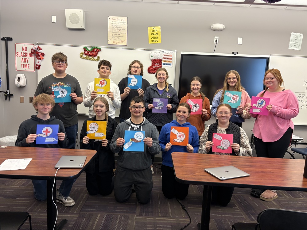 Junior Financial Literacy students displaying their chosen charitable organization.