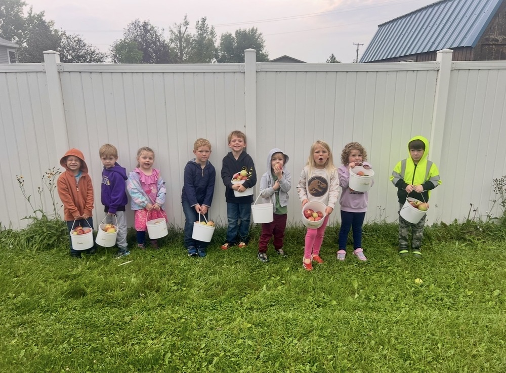 Preschoolers with their buckets of apples