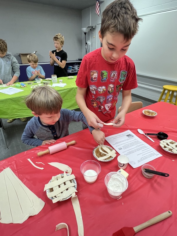 preschoolers with buddies making pies