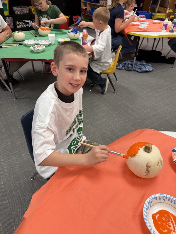 preschoolers paint pumpkins