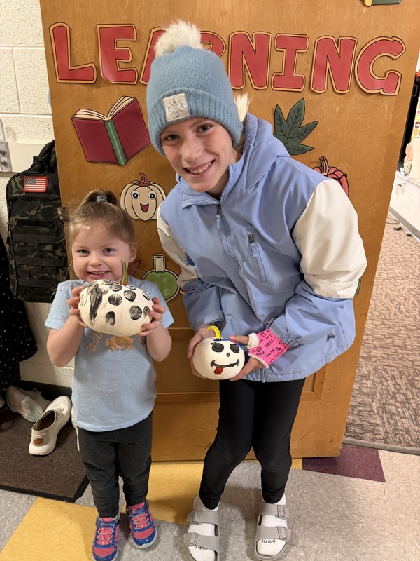 preschoolers paint pumpkins