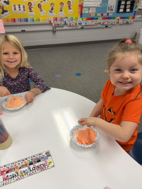 Preschoolers painting pumpkins