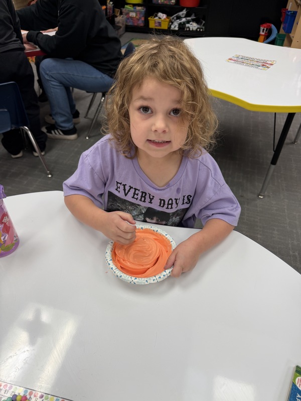 Preschoolers painting pumpkins