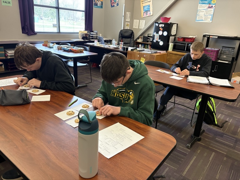 More students "mining" chocolate chips from cookies.