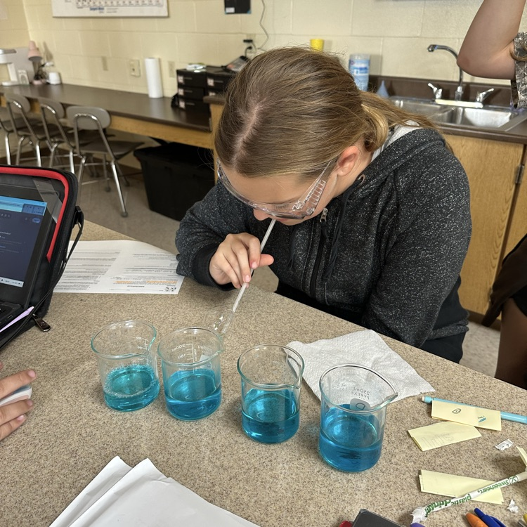 student blowing bubbles during bubble buster lab