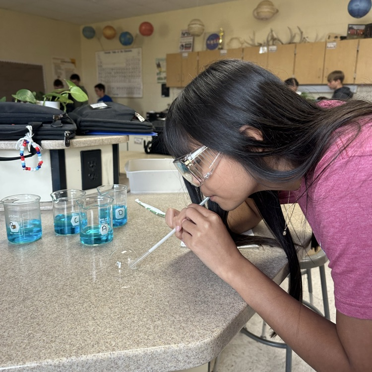 student blowing bubbles during bubble buster lab