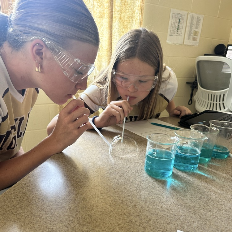 student blowing bubbles during bubble buster lab
