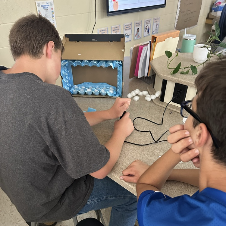 students working on soundproof boxes