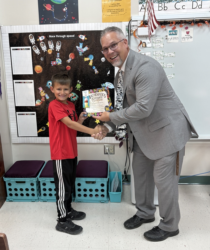 Rykker Wilson accepting his math facts award from Mr. Scifres