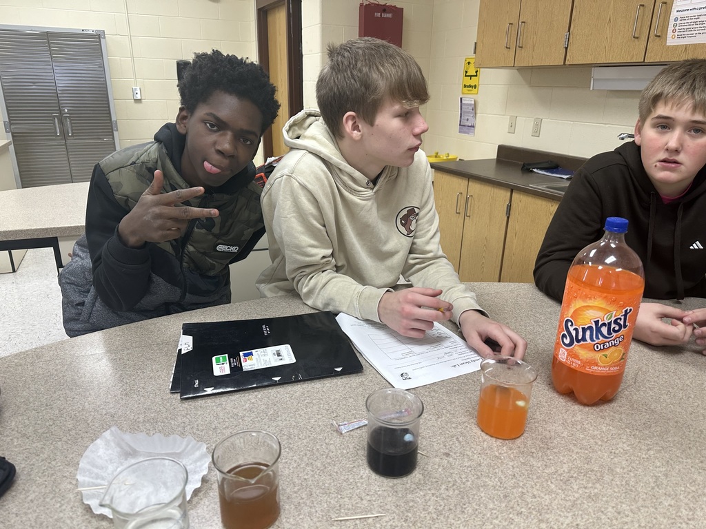 Students testing how fast candy hearts dissolve in various liquids