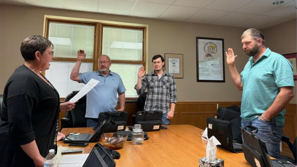 Tracy Gonnerman swearing in Lewis County C-1 's newest board members; Allen Brinkley, Michael Scoggin, & Jake Hedges during the 4/17/26 board reorganization meeting held in the LCC-1 central office.