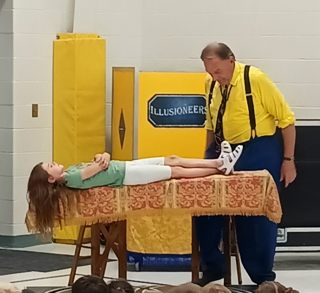 Student "levitating" during magician act
