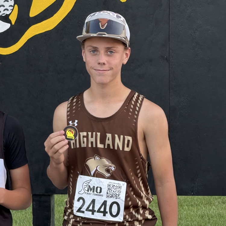 Nick Caudill holding his 6th place medal from the CCC conference meet.