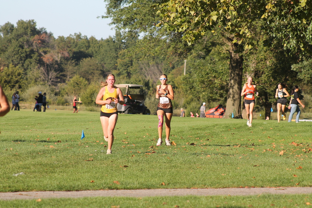 AJ Caudill on the heals of a Monroe City runner approaching the finish at Monroe City.