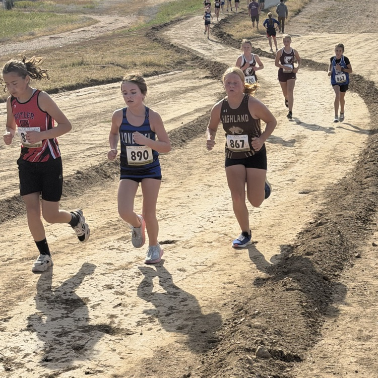 Leah Caudill heading into a big hill and challenging two runners during the final mile of the race.