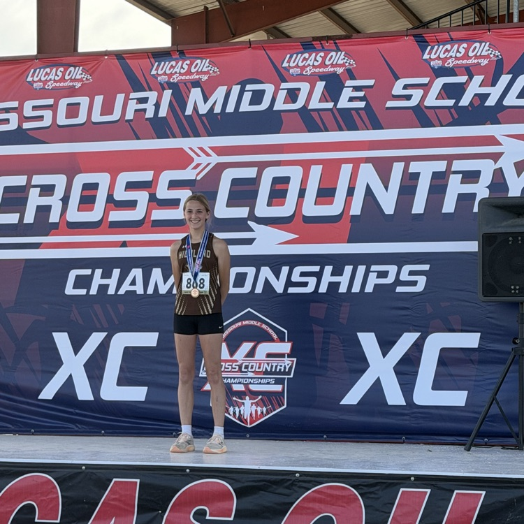 Natalie Wilson - All State Medalist for the Lady Cougars MS XC team on stage accepting her 25th place medal!