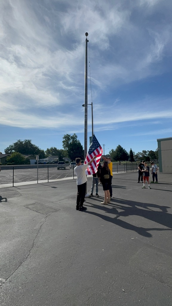 students learning how to retire the flag