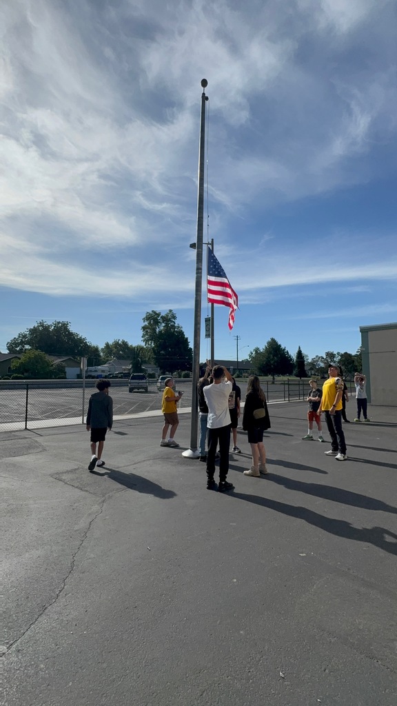 students learning how to retire the flag