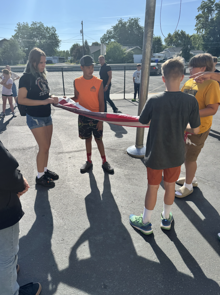 students learning how to retire the flag