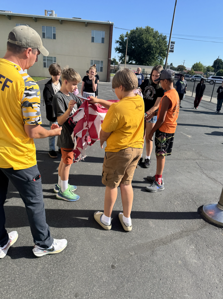 students learning how to retire the flag