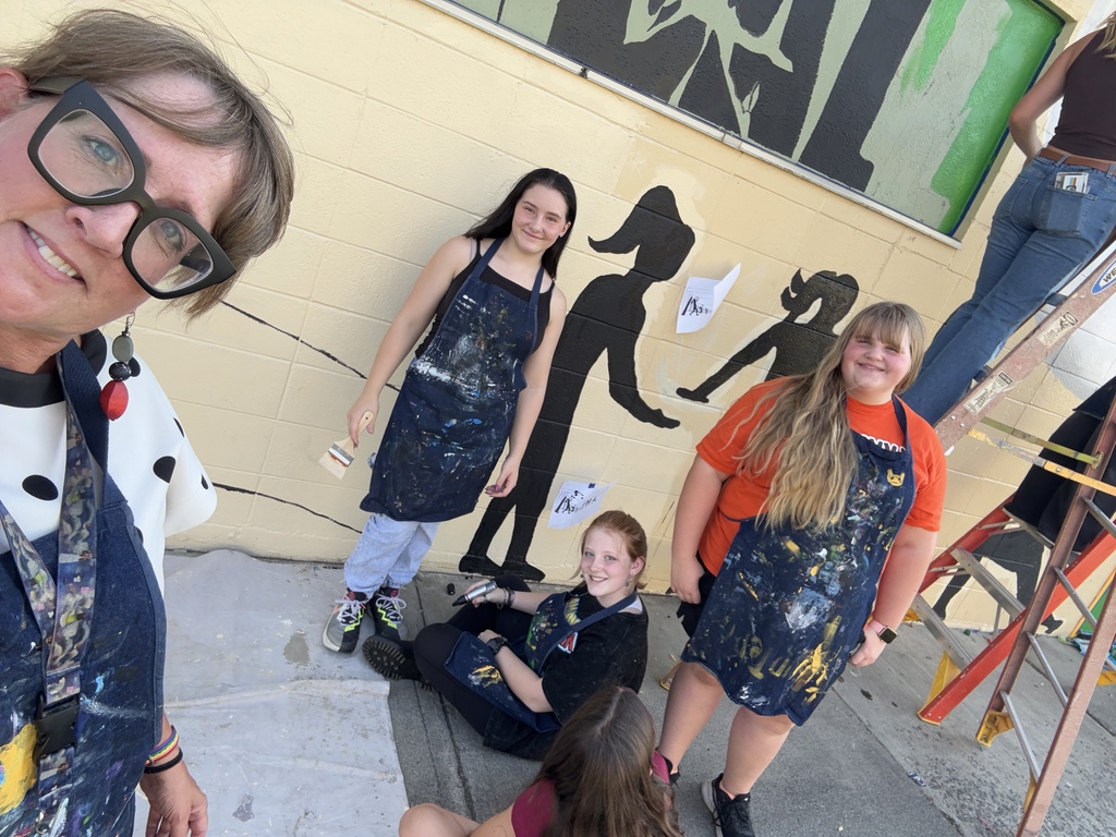 students working on painting murals 