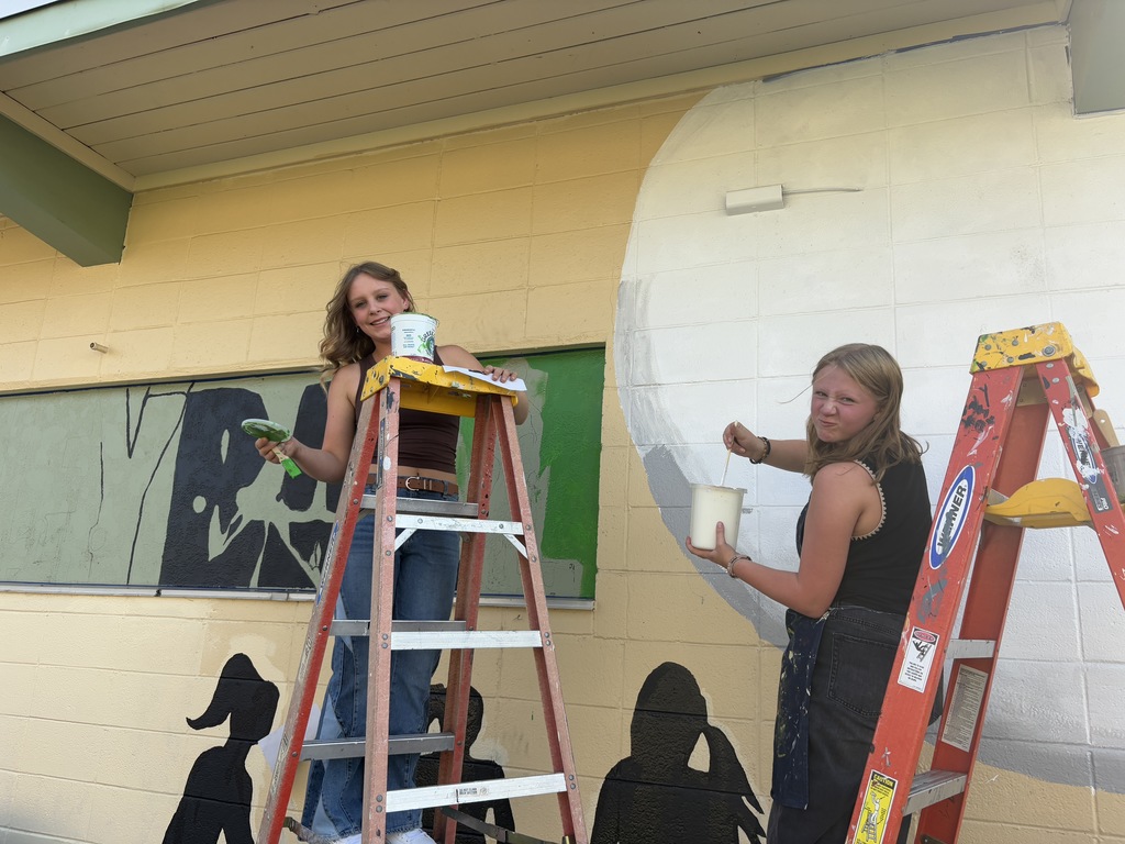 students working on painting murals 