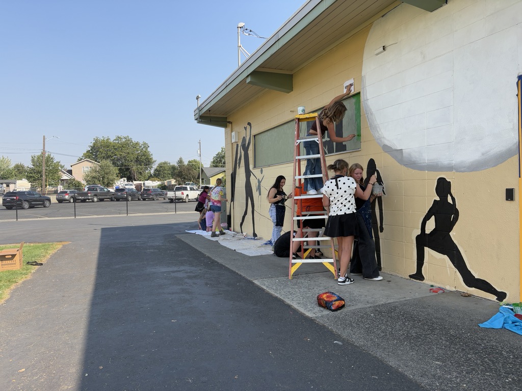 students working on painting murals 