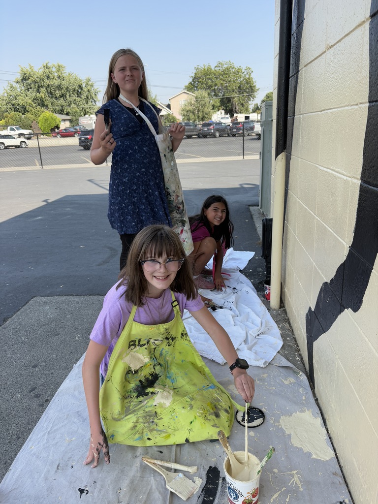 students working on painting murals 
