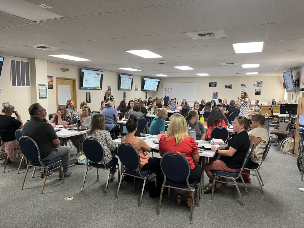 teachers sitting together at tables and learning