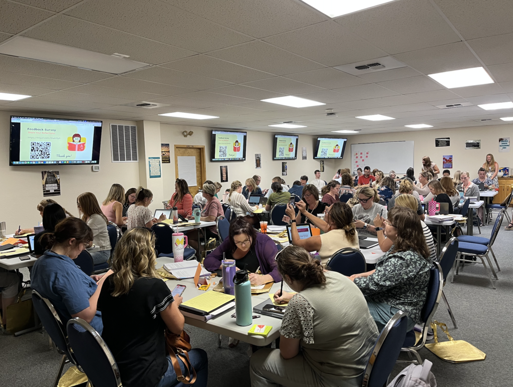 teachers sitting together at tables and learning