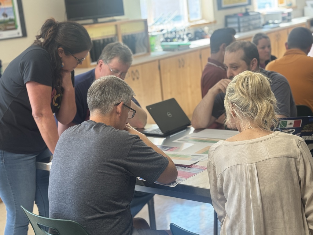 staff working together at desks with laptops