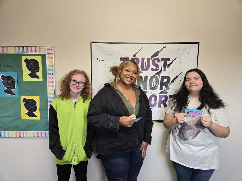 3 students standing together smiling