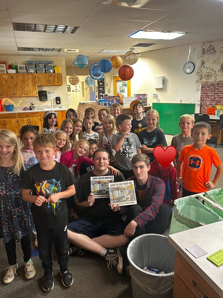 students in a group holding a book