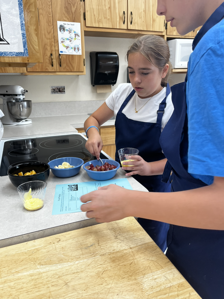 students slicing fruit