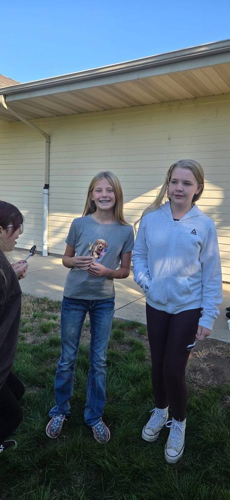 students passing an egg with spoons