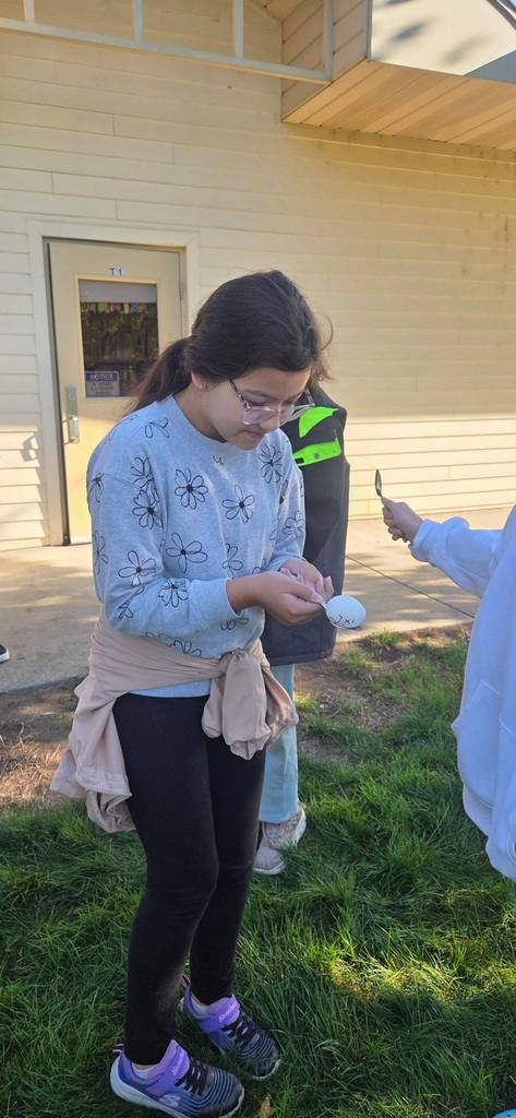 students passing an egg with spoons