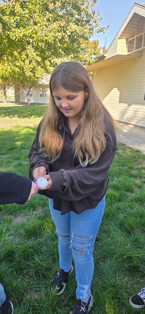 students passing an egg with spoons
