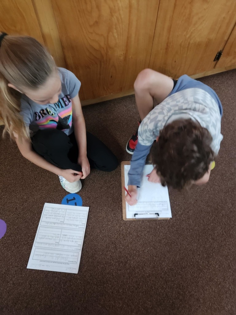 students working together using clipboards