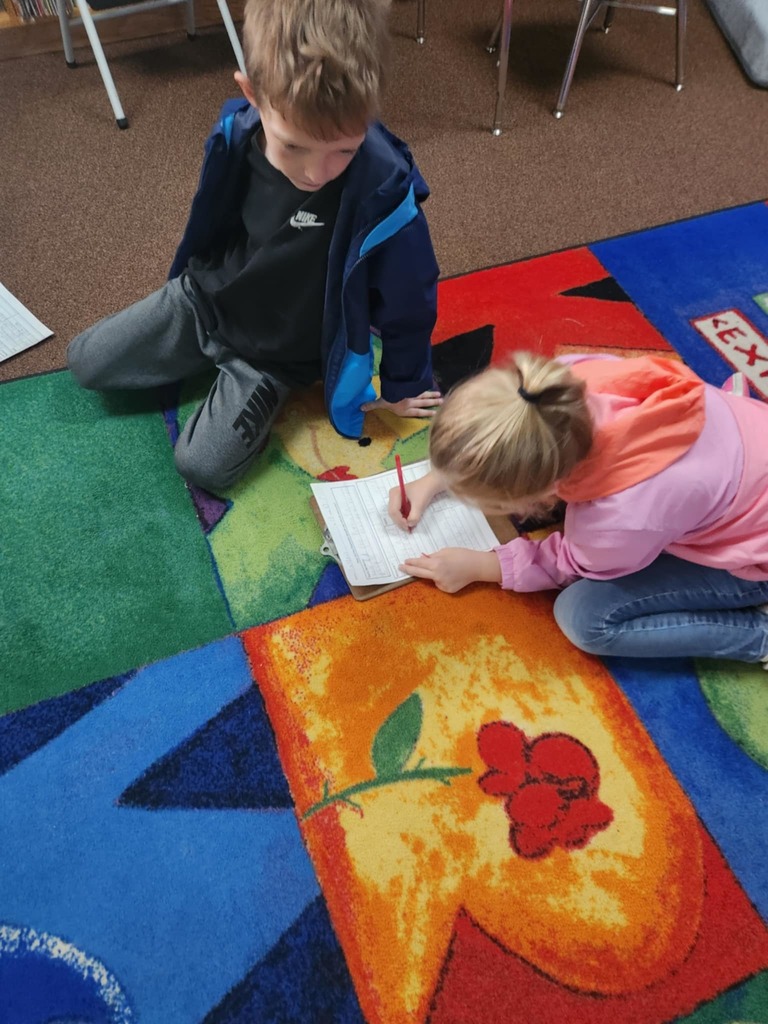 students working together using clipboards