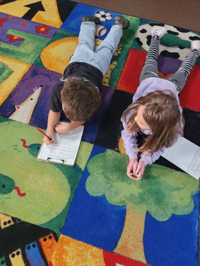 students working together using clipboards