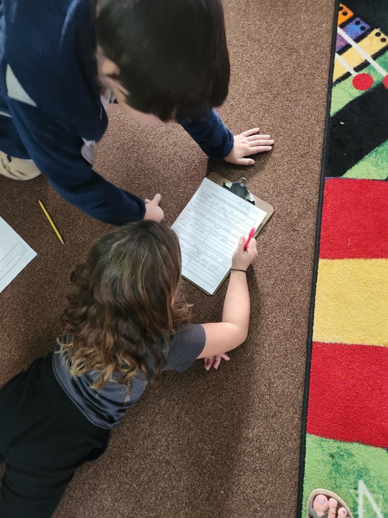 students working together using clipboards