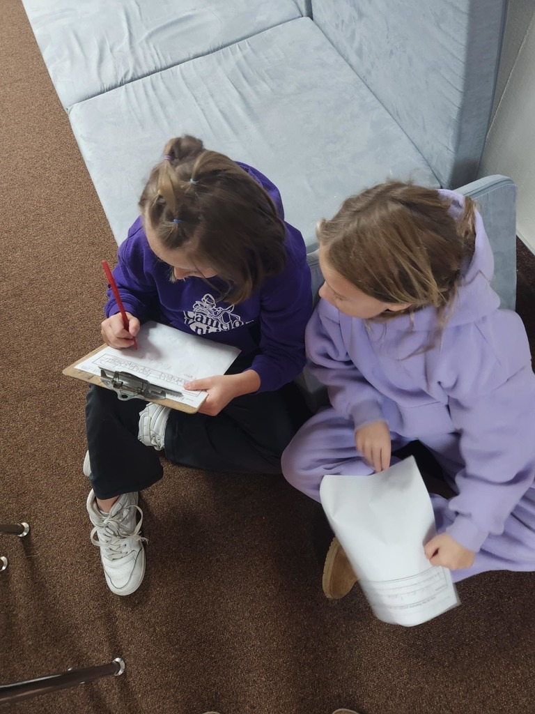 students working together using clipboards